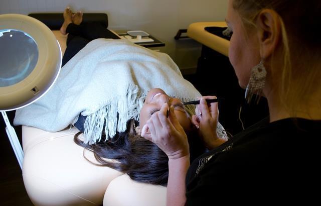 A technician applies eyelash extensions at the Lash Loft A technician applies eyelash extensions at the Lash Loft