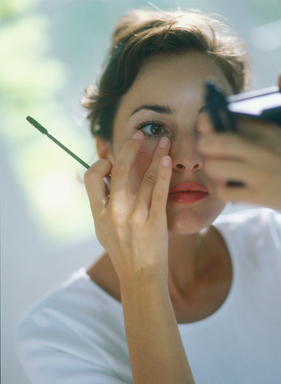 Woman applying mascara Woman applying mascara
