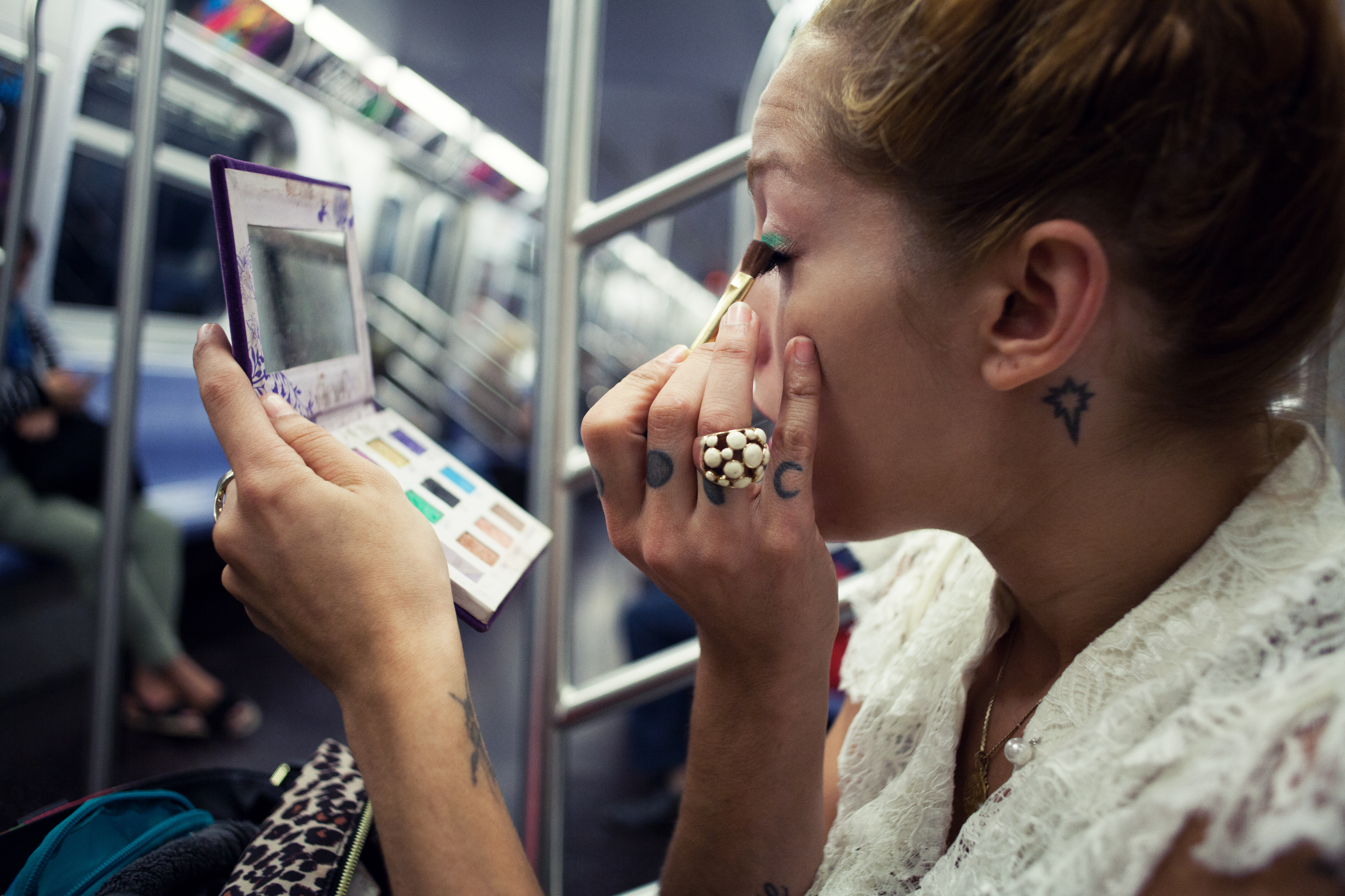 doing makeup on subway